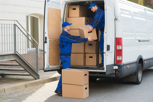Man and van loading boxes outside a North Woolwich apartment building
