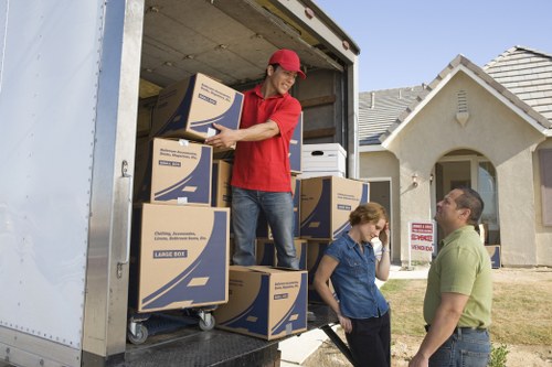 Local movers packing household items carefully in North Woolwich