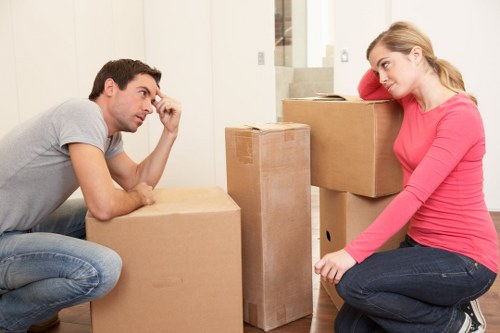 Local moving team handling boxes and furniture in North Woolwich